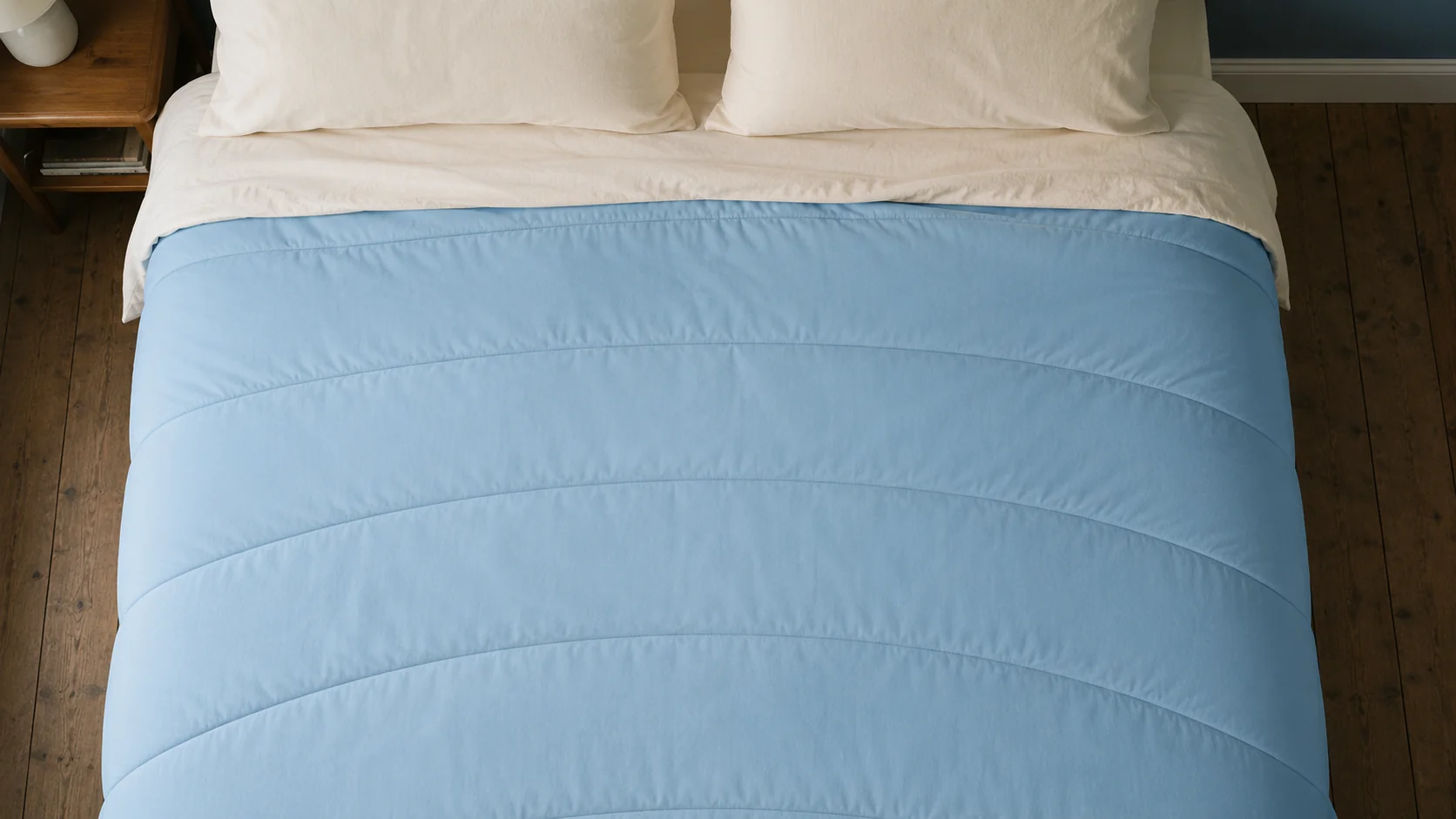 The blanket photographed flat from directly above, its quilted channels reading as a pattern.